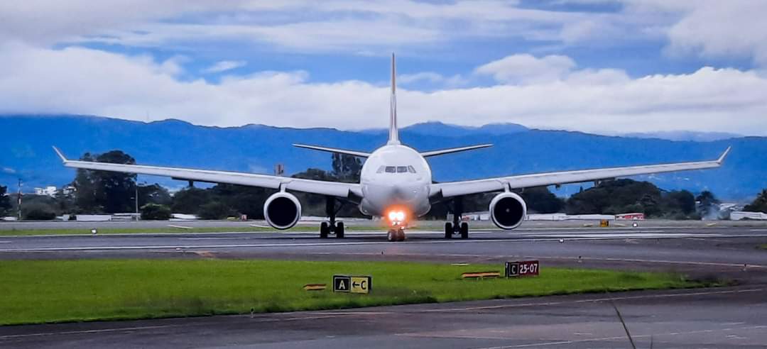 plane on a runway under a cloudy sky