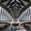 view inside Lyon Airport's unique v-shaped concourse with windows all around and a vaulted ceiling