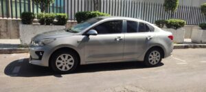 Cancun Airport Taxi Sedan - Welcome Pickups A silver Cancun Airport taxi sedan parked on the side of a sunny street, featuring four doors, tinted windows, and compact styling; commonly used for private airport transfers from Cancun Airport.
