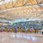 A huge rod and glass ceiling over the entrance to Hamburg Airport.