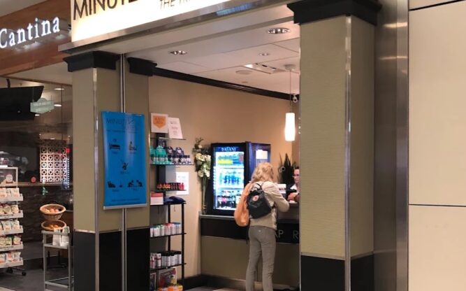 A woman standing at the entrance to the Minute Suites nap and hotel facility at Dallas Airport