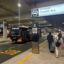 Tourists at Auckland airport bus stop New Zealand