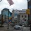 street of Buffalo with cars and an American flag overhead