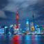 A view of Shanghai city lit up at night reflected in the water