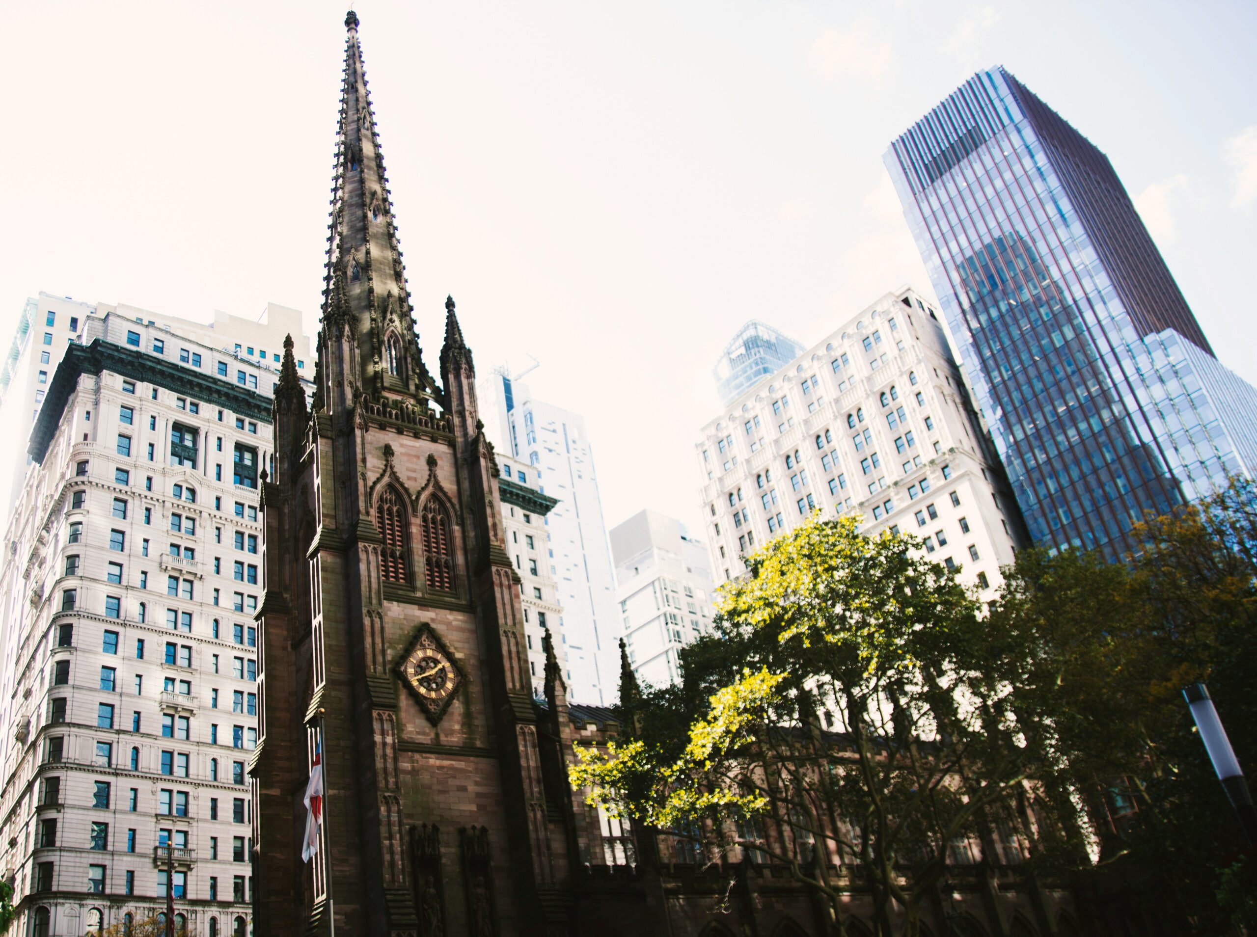 A view of a church in front of city buildings