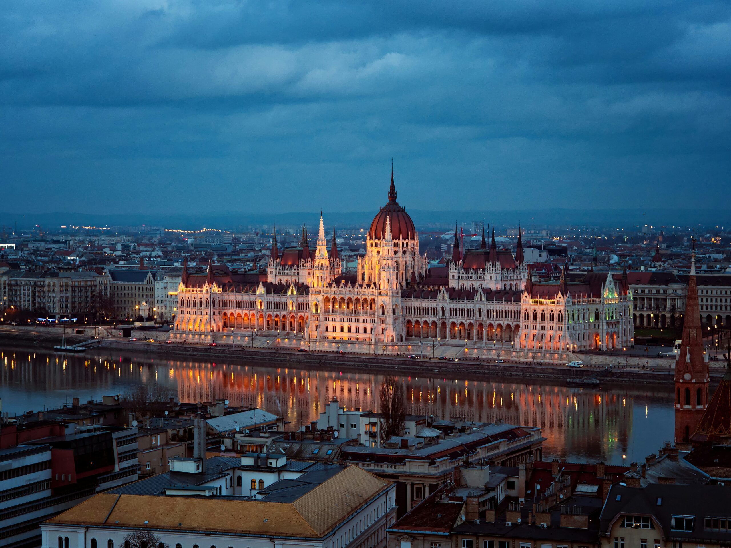 The grand Hungarian Parliament Building dominating the city skyline at night